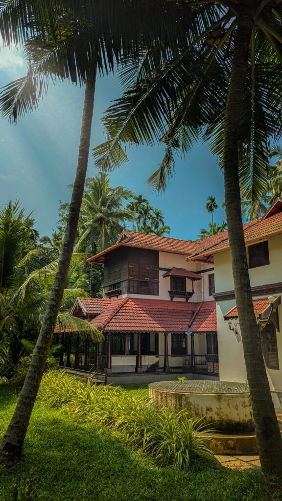 Experience a luxurious stay surrounded by lush greenery and traditional architecture in Kerala, India.